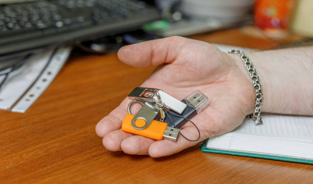 different USB flash drives are in the man's hand stock photo