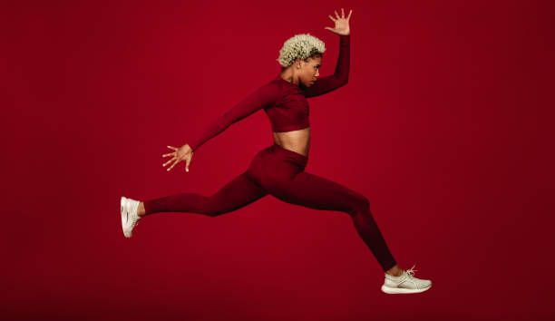 istock Side view of female athlete running 1284549396