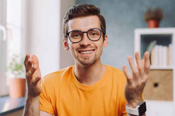 istock Head shot via webcam of young smiling man in glasses 1284549907