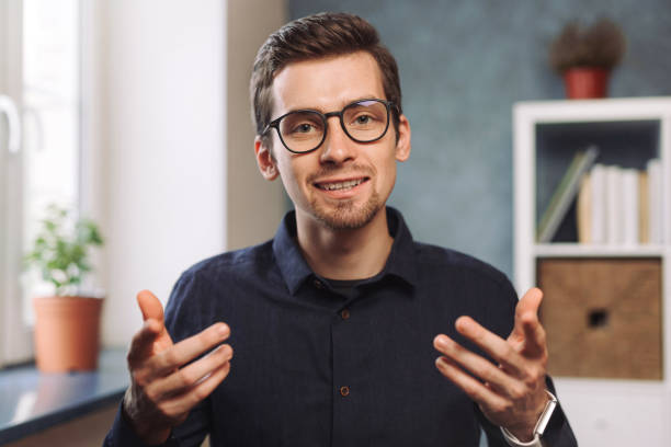 istock Young school tutor giving online class from home via video call 1284550569
