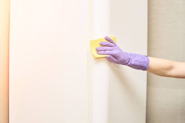 istock Hand in protective glove cleaning fridge. White kitchen furniture 1284551049