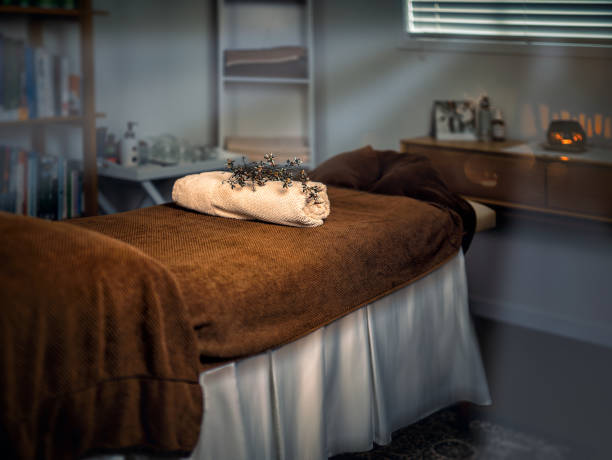 istock Massage table with towels and candle in a cabinet 1284554107