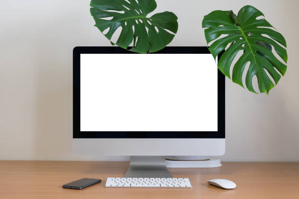 istock Blank screen of All in one Computer with Monstera and smartphone 1284555307