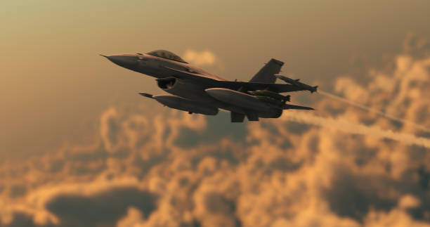 istock Fighter jet flies at high speed above the clouds 1284556323