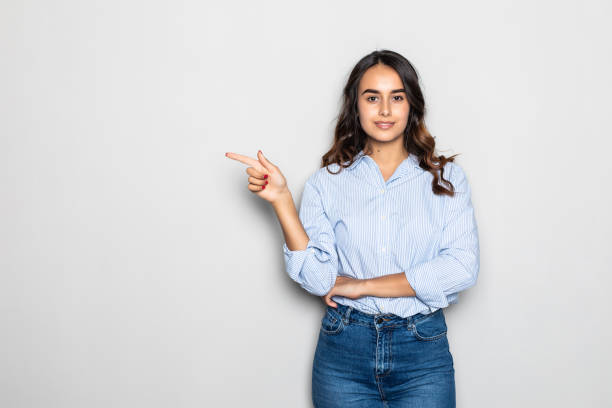 istock Happy cute girl pointed side over gray background 1284556915