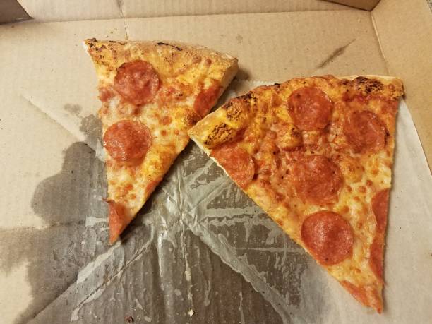 istock slices of pepperoni pizza with grease in box 1284559403