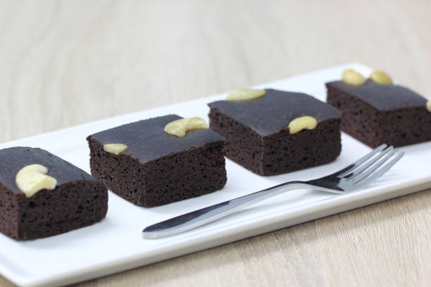 istock Chocolate brownie squares on white background 1284561876