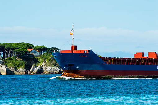 freighter ship entering Santander bay near the beach