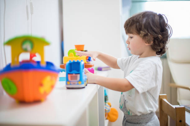 istock Beautiful toddler boy playing with his toys. 1284565113