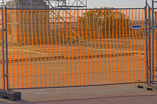 Orange plastic fence structure at construction site