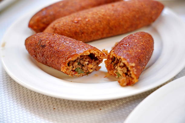 istock traditional Hatay meal oruk (icli kofte) and  tray (tepsi) kebab 1284572670