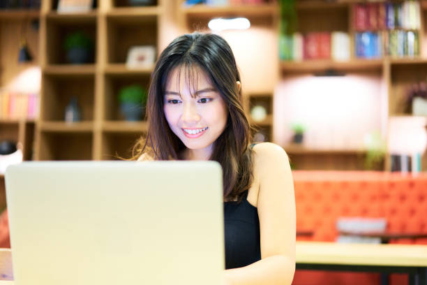 istock Asian woman telecommuting from cafe 1284573156