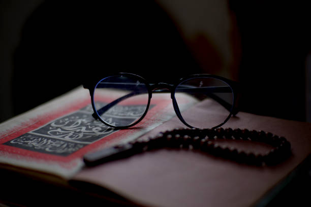 istock Glasses and prayer beads on the ancient holy Koran 1284574068