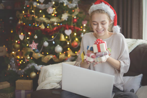 istock young woman in christmas interior with laptop  ( e-commerce) 1284575200