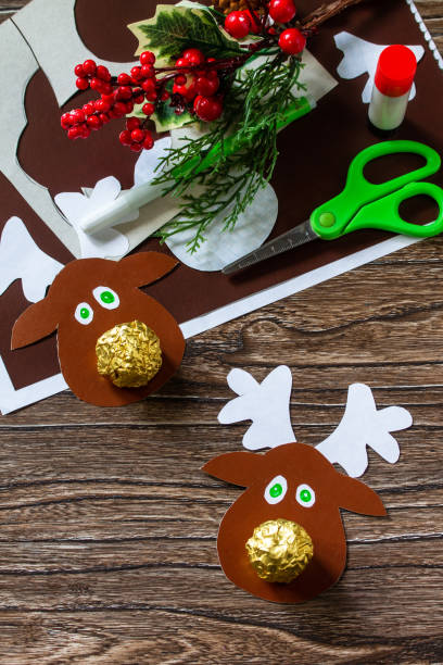 istock Funny Gift with candy Christmas deer. Handmade. Children's creativity project, crafts, crafts for kids. 1284576511