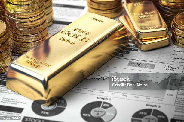 Gold Bar Ingots And Coins On Financial Report Growth Of Gold On Stock Market Concept Stock Photo - Download Image Now
