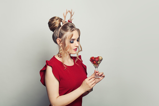 Attractive Christmas woman with Xmas decorations on white background portrait