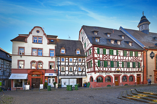 Weinheim, Germany - November 2020: Historic city center with traditiona old half timbered buildings in Weinheim city on sunny day