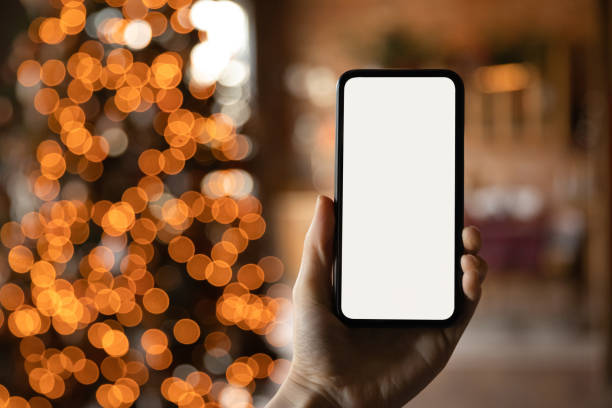 istock Close up smartphone with empty screen mockup on holiday background 1284578730