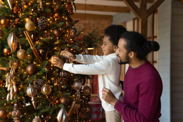 istock Loving African American father with little son decorating Christmas tree 1284578734