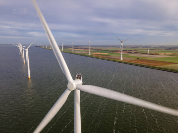 istock offshore windmill park with clouds and a blue sky, windmill park in the ocean drone aerial view with wind turbine 1284579943