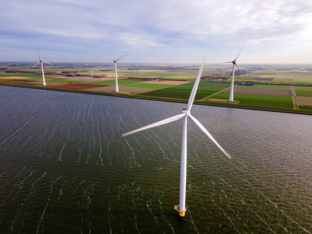 istock offshore windmill park with clouds and a blue sky, windmill park in the ocean drone aerial view with wind turbine 1284580837