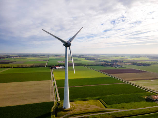 istock offshore windmill park with clouds and a blue sky, windmill park in the ocean drone aerial view with wind turbine 1284580971