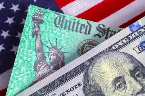 istock Hundred Dollar Bill With Tax Refund and Flag 1284580990