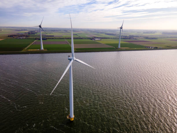 istock offshore windmill park with clouds and a blue sky, windmill park in the ocean drone aerial view with wind turbine 1284583095