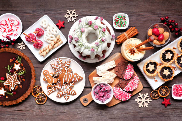 istock Various Christmas holiday desserts and sweets. Overhead view table scene on a wood background. 1284583246