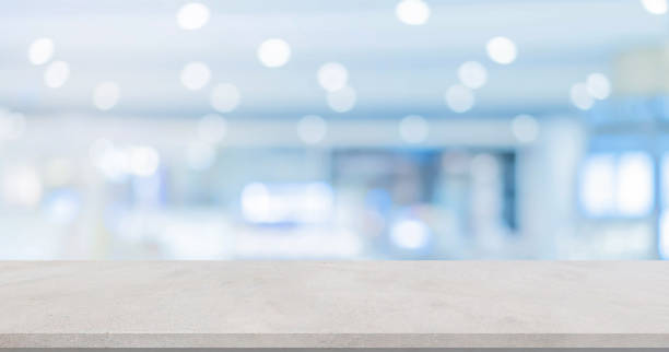 istock abstract blur inside modern hospital building background with white concrete table for show , promote product or and advertise on display concept 1284583351