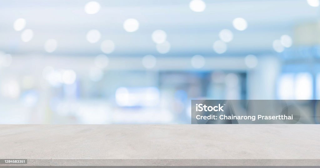 abstract blur inside modern hospital building background with white concrete table for show , promote product or and advertise on display concept Table Stock Photo