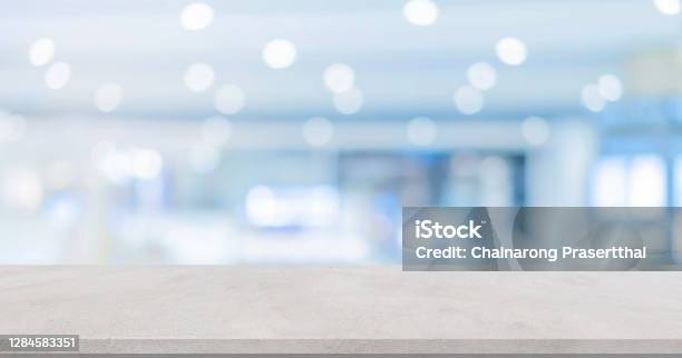 Abstract Blur Inside Modern Hospital Building Background With White Concrete Table For Show Promote Product Or And Advertise On Display Concept Stock Photo - Download Image Now