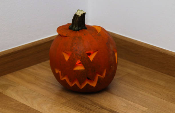 istock halloween pumpkin with candle 1284583510