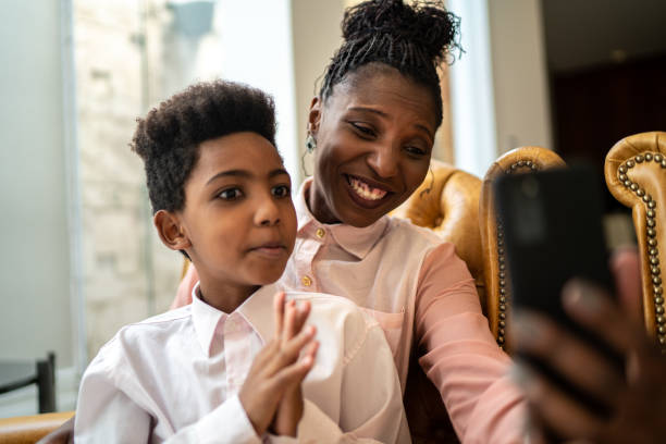istock Mother and son doing a video call on smartphone at home 1284584159