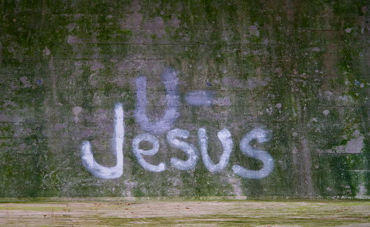 The word JESUS on a black board
