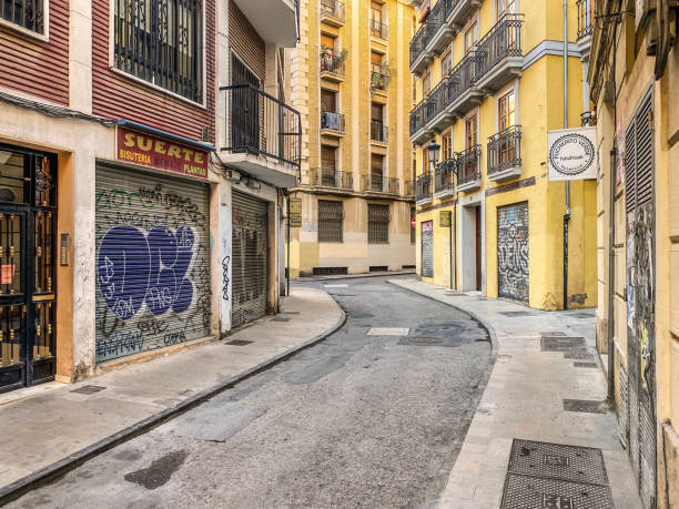 Valencia, Spain - November 1, 2020: Narrow street in the historic center of the city. In this area almost no cars get in as it becomes nearly imposible to drive