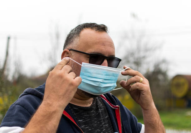 istock Touching the medical mask properly- concept 1284584906