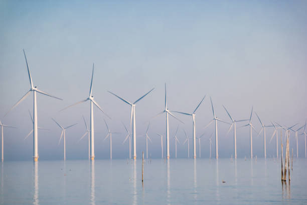 istock offshore windmill park with clouds and a blue sky, windmill park in the ocean drone aerial view with wind turbine 1284585455