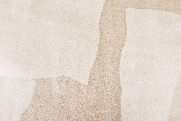 istock White plastic foam sheet pieces on cardboard background. 1284585517