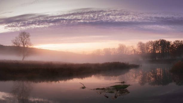 Photo of Autumn landscape fog over river and sky with rising sun