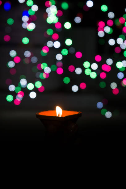 istock Diwali Diya (oil lamp) in hands with bokeh background. 1284588386