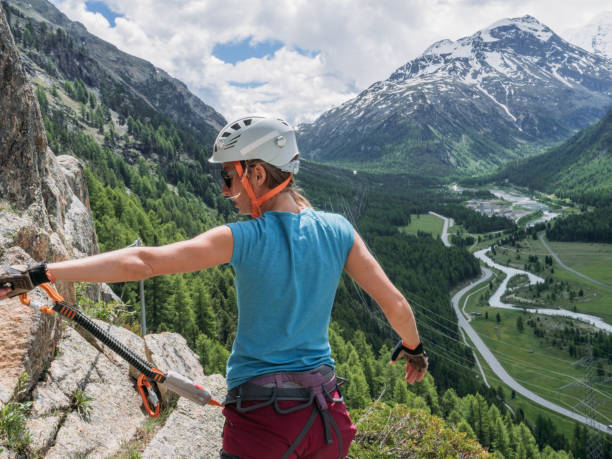 istock Young women on Via Ferrata moving up climbing rock 1284589832