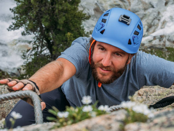 Wide angle view of sporty man climbing in summer on Via Ferrata in Switzerland