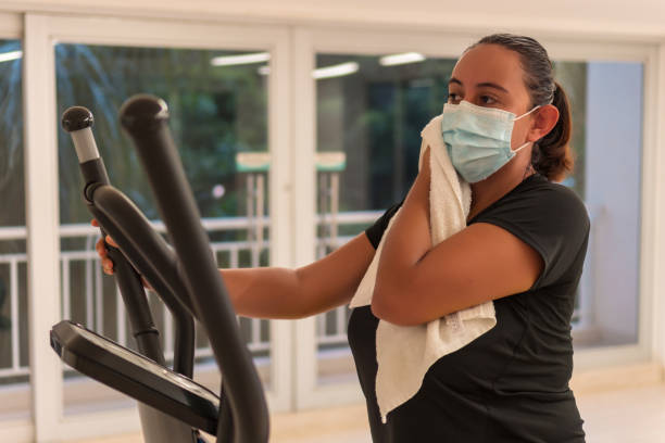 istock Woman with protective mask drying her sweat during training 1284591794