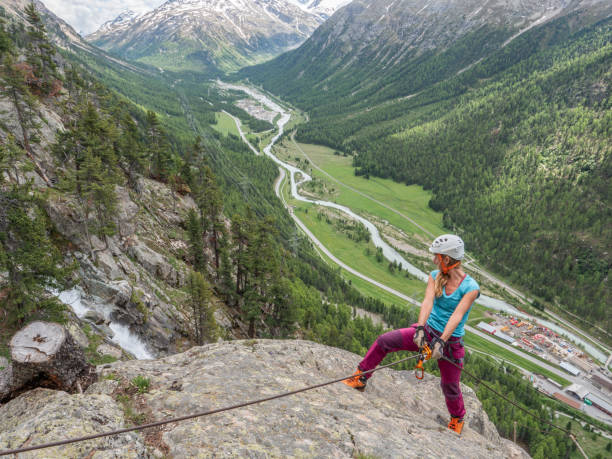 istock Young women on Via Ferrata moving up climbing rock 1284591899
