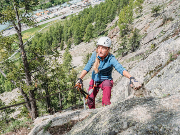 istock Young women on Via Ferrata moving up climbing rock 1284592873