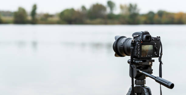 istock Digital SLR camera mounted on a tripod. Shooting a landscape. 1284593576