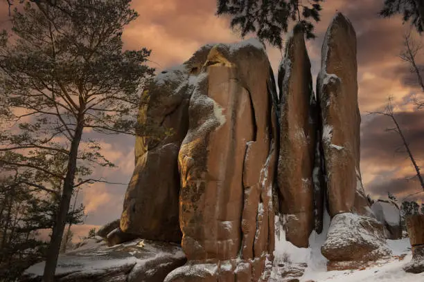 Photo of Feathers Rock in the Stolby Nature Sanctuary the city of Krasnoyarsk, Russia, Siberia. Majestic dusk at winter landscape.