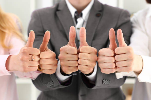 istock Company team workers showing thumbs up in office 1284594339